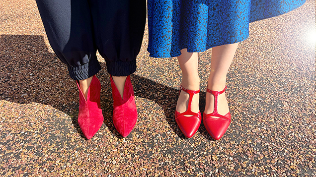Two people wearing red shoes lined up next to each other